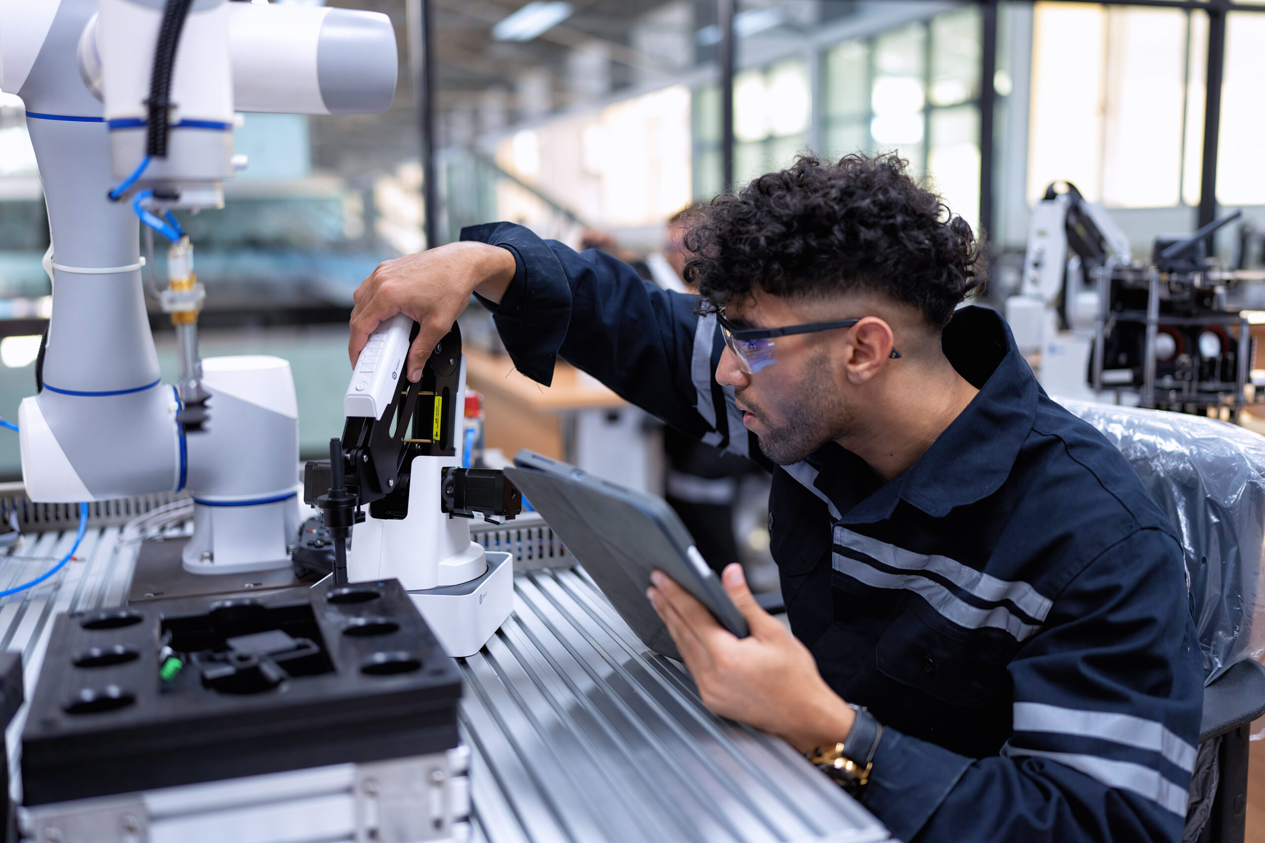 man-inspecting-automated-manufacturing-robot-in-wo-2026-01-05-05-58-09-utc