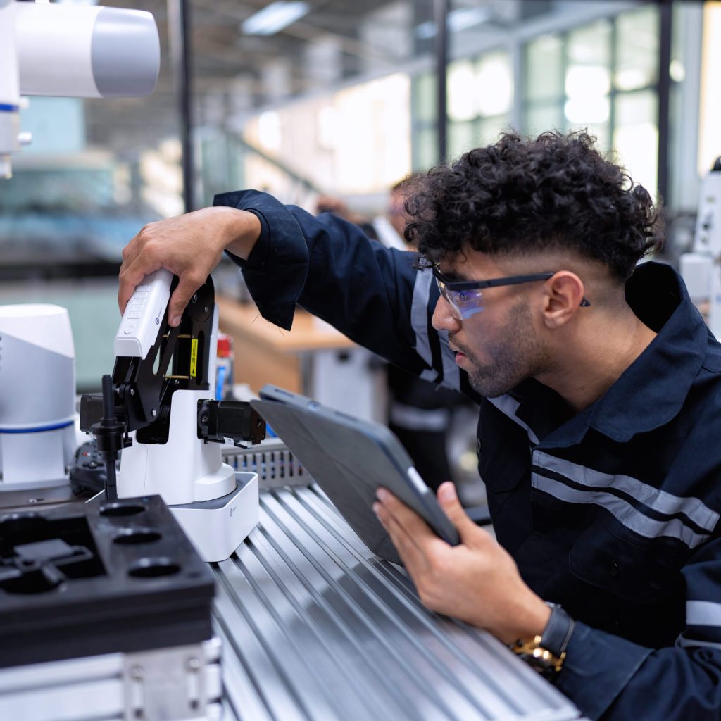 man-inspecting-automated-manufacturing-robot-in-wo-2026-01-05-05-58-09-utc
